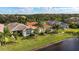 Aerial view of homes with lake view and lush landscaping at 4817 Sandy Glen Way, Wimauma, FL 33598