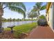 Brick patio overlooks a peaceful lake with lush landscaping at 4817 Sandy Glen Way, Wimauma, FL 33598