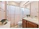 Clean bathroom with a shower/tub combo and wood vanity at 4817 Sandy Glen Way, Wimauma, FL 33598