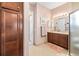 Bathroom with single vanity and walk-in shower at 4817 Sandy Glen Way, Wimauma, FL 33598
