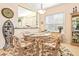 Bright dining room featuring a glass-top table and floral chairs at 4817 Sandy Glen Way, Wimauma, FL 33598
