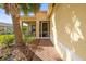 Charming entryway with brick walkway, leading to a screened-in porch and front door at 4817 Sandy Glen Way, Wimauma, FL 33598