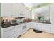 Modern kitchen with white cabinets, granite counters, and stainless steel appliances at 4817 Sandy Glen Way, Wimauma, FL 33598