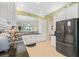 Well-equipped kitchen boasts white cabinets, granite countertops and black appliances at 4817 Sandy Glen Way, Wimauma, FL 33598