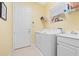 Laundry room with washer, dryer, and extra storage at 4817 Sandy Glen Way, Wimauma, FL 33598