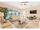 Living area featuring comfortable sofas and a large TV at 4817 Sandy Glen Way, Wimauma, FL 33598