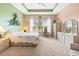 Spacious main bedroom with a large window overlooking a pond at 4817 Sandy Glen Way, Wimauma, FL 33598