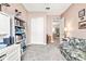 Bright home office features built-in shelving and a comfortable sofa at 4817 Sandy Glen Way, Wimauma, FL 33598