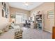 Home office with built-in shelving, desk and comfortable seating at 4817 Sandy Glen Way, Wimauma, FL 33598