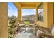 Relaxing front porch with wicker furniture, providing a peaceful outdoor space at 4817 Sandy Glen Way, Wimauma, FL 33598