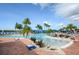 Relaxing pool area with lounge chairs and palm trees at 4817 Sandy Glen Way, Wimauma, FL 33598