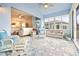 Bright sunroom with water views, comfortable seating, and large windows at 4817 Sandy Glen Way, Wimauma, FL 33598
