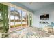 Relaxing sunroom with water views and wicker furniture at 4817 Sandy Glen Way, Wimauma, FL 33598