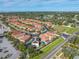 Aerial view of a house with a pool and solar panels at 4943 Grand Oak Cir, Madeira Beach, FL 33708
