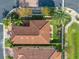 Top-down aerial view of a house with a red tile roof and a small backyard at 4943 Grand Oak Cir, Madeira Beach, FL 33708