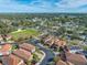 Aerial view of houses in a community with solar panels at 4943 Grand Oak Cir, Madeira Beach, FL 33708