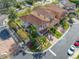 Aerial view of a house with red tile roof, landscaping, and a street view at 4943 Grand Oak Cir, Madeira Beach, FL 33708