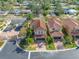 Aerial view of a house with a red tile roof and gated community at 4943 Grand Oak Cir, Madeira Beach, FL 33708