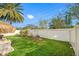 Large backyard with grassy area and decorative plants at 4943 Grand Oak Cir, Madeira Beach, FL 33708