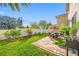 Spacious backyard with patio, grass, and a dining area at 4943 Grand Oak Cir, Madeira Beach, FL 33708