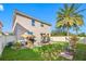 Landscaped backyard featuring a patio and lush lawn at 4943 Grand Oak Cir, Madeira Beach, FL 33708
