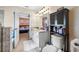 Bathroom with double vanity and view into bedroom at 4943 Grand Oak Cir, Madeira Beach, FL 33708