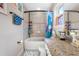 Bathroom with tub shower, granite vanity, and window at 4943 Grand Oak Cir, Madeira Beach, FL 33708