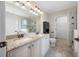 Bathroom featuring double sinks, granite countertops, decorative lighting, tiled floors, and glass shower at 4943 Grand Oak Cir, Madeira Beach, FL 33708