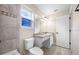 Cozy bathroom with tub, vanity, granite counter, and white cabinets, complemented by a window and ample lighting at 4943 Grand Oak Cir, Madeira Beach, FL 33708