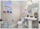 Small bathroom with pedestal sink and decorative accents at 4943 Grand Oak Cir, Madeira Beach, FL 33708