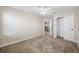 Neutral bedroom featuring a ceiling fan, carpet, and closet at 4943 Grand Oak Cir, Madeira Beach, FL 33708
