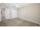 Neutral-toned bedroom featuring carpet, closet, and access to the hallway at 4943 Grand Oak Cir, Madeira Beach, FL 33708