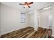 This bedroom includes hardwood floors, a ceiling fan, and an attached bathroom at 4943 Grand Oak Cir, Madeira Beach, FL 33708