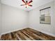 Cozy bedroom with wood flooring, a ceiling fan, and a window at 4943 Grand Oak Cir, Madeira Beach, FL 33708
