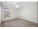 Inviting bedroom with neutral paint, carpet flooring, ceiling fan, and window offering natural light at 4943 Grand Oak Cir, Madeira Beach, FL 33708