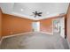 Bedroom featuring neutral paint, carpet floors, tray ceiling, and a view of the hallway through the door at 4943 Grand Oak Cir, Madeira Beach, FL 33708