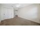 Neutral bedroom with double closet, neutral carpet, and ceiling fan at 4943 Grand Oak Cir, Madeira Beach, FL 33708
