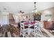 Dining area with farmhouse table and chairs, adjacent to living room and kitchen at 4943 Grand Oak Cir, Madeira Beach, FL 33708