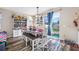 Bright dining area with a farmhouse table, bench seating, and sliding glass door to backyard at 4943 Grand Oak Cir, Madeira Beach, FL 33708