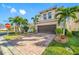 Two-story house with brown garage door and landscaping, viewed from the street at 4943 Grand Oak Cir, Madeira Beach, FL 33708