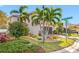 Two-story house with brown garage door and landscaping, viewed from the side at 4943 Grand Oak Cir, Madeira Beach, FL 33708