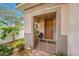 Inviting front entry with a brown door, landscaped garden, and a metal gate at 4943 Grand Oak Cir, Madeira Beach, FL 33708