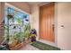 Welcoming front porch featuring terracotta tile flooring and lush potted plants at 4943 Grand Oak Cir, Madeira Beach, FL 33708