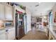 Open kitchen with stainless steel appliances and a view into the dining area at 4943 Grand Oak Cir, Madeira Beach, FL 33708