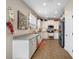 Modern kitchen featuring granite countertops, white cabinets, and stainless steel appliances at 4943 Grand Oak Cir, Madeira Beach, FL 33708