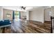 Spacious living room with hardwood floors and sliding doors to outdoor space at 4943 Grand Oak Cir, Madeira Beach, FL 33708