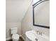 Clean bathroom with white sink and toilet, and a blue framed mirror at 8304 Sandstone Ct, Tampa, FL 33615