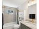 Updated bathroom with a tub, shower, and stylish vanity at 8304 Sandstone Ct, Tampa, FL 33615