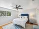 Bright bedroom with a blue headboard, white bedding and hardwood floors at 8304 Sandstone Ct, Tampa, FL 33615