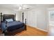 Bedroom with hardwood floors, a dark wood bed frame and a closet at 8304 Sandstone Ct, Tampa, FL 33615